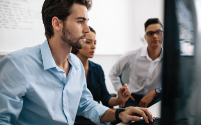 Three People Viewing a Computer Monitor