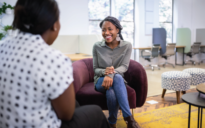 Two People Seated on Plush Chairs