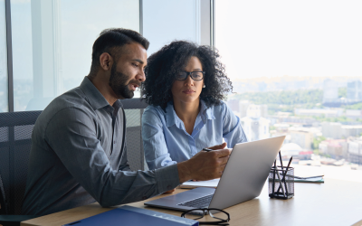 Two People Looking at a Laptop Screen